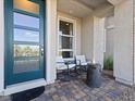 Inviting front porch with a modern fire pit, seating, and a stylish blue front door at 108 Kimberlite Dr, Henderson, NV 89011