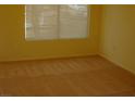 Bedroom with neutral carpet, and a window letting in natural light at 108 Zenith Point Ave, North Las Vegas, NV 89032