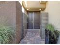 Inviting front entrance with double doors, gray privacy screens and a brick-paved entryway at 12 Hilltop Crest St, Henderson, NV 89011