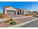 Charming single-story home showcasing a three-car garage and a well-maintained, landscaped front yard at 136 Mosso Niente Pl, Henderson, NV 89011