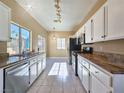 Bright kitchen with stainless steel appliances, white cabinets and light countertops at 1851 Hillpointe Rd # 2124, Henderson, NV 89074