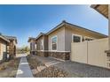 Side view of home showcasing a well-kept yard and stylish exterior design at 216 Copland Canyon Ave, Henderson, NV 89011