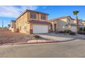 Attractive home featuring a two-car garage, desert landscaping, and a tiled roof at 2737 Sunrise Day Ct, Las Vegas, NV 89142