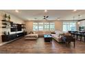 Spacious living room featuring a large sectional sofa and wood-look floors at 3498 Monte Cervino Ave, Henderson, NV 89044