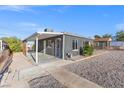 Side view of a gray house with a covered patio and gravel landscaping at 465 Federal St, Henderson, NV 89015