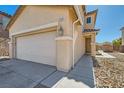 Charming tan two-story home featuring a spacious two-car garage, front door, and rock landscaping at 5329 Fireside Ranch Ave, Las Vegas, NV 89131