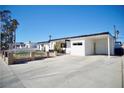 Welcoming white single-story home with desert landscaping and an extended carport at 5732 Heron Ave, Las Vegas, NV 89107