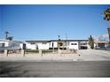 Inviting single-story home with desert landscaping, complemented by a stone fence at 5732 Heron Ave, Las Vegas, NV 89107