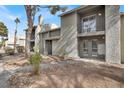 View of the condo building exterior, highlighting the entryways and desert landscaping at 584 Sellers Pl, Henderson, NV 89011