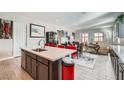 Open concept kitchen with a large island, connecting to the dining and living areas at 6016 La Coste St, North Las Vegas, NV 89081