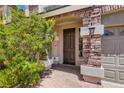 Inviting front entrance with decorative stone columns and lush landscaping at 6250 Sierra Knolls Ct, Las Vegas, NV 89139