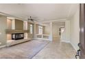 Open-concept living room featuring a modern fireplace and neutral decor at 6250 Sierra Knolls Ct, Las Vegas, NV 89139