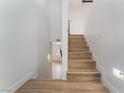 Modern light wood staircase leading to the upper level at 6885 Stone Dr, Las Vegas, NV 89110