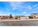 Inviting single-story home with a three-car garage, desert landscaping, and extra storage on the driveway at 7076 Oakleigh Dr, Las Vegas, NV 89110