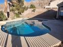 Inviting backyard pool with a beautiful view of desert landscaping and hills in the background at 7076 Oakleigh Dr, Las Vegas, NV 89110