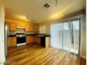 Kitchen featuring oak cabinets, black appliances and direct access to the backyard at 7949 Long Beach St, Las Vegas, NV 89139