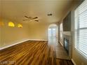 Open-concept living room with a ceiling fan, fireplace and vinyl plank flooring at 7949 Long Beach St, Las Vegas, NV 89139