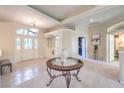 Elegant foyer featuring tile floors, large windows, and a decorative table at 8875 Steven Chase Ct, Las Vegas, NV 89149