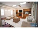 Bright living room with a fireplace and built-in entertainment center at 9408 Forest Edge Ave, Las Vegas, NV 89149