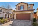 Two-story house with brown garage door and brick driveway at 9875 Vista Meadows Ave, Las Vegas, NV 89148