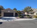 Beautiful single-story home boasts a well-maintained front yard, desert landscaping, and an attached garage at 10709 Hunters Woods Pl, Las Vegas, NV 89134