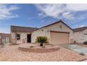 Attractive single-story home boasting desert landscaping, a terra cotta roof, and an attached two-car garage at 1073 Silver Bullet Ct, Henderson, NV 89011