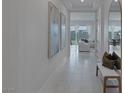 Hallway with view into living room and art pieces at 11671 Hatchling Ave, Las Vegas, NV 89138