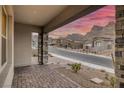 Covered porch with mountain views and brick flooring at 11671 Hatchling Ave, Las Vegas, NV 89138