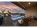 Inviting backyard featuring a pool, spa, and cozy outdoor seating area under a covered patio at 11900 Star Grass Ave, Las Vegas, NV 89138