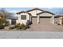 Charming home featuring a well-manicured front yard and an attached two-car garage at 11900 Star Grass Ave, Las Vegas, NV 89138