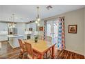 Charming dining area with wooden table and chairs, adjacent to the kitchen at 1544 Tilman Ln, Boulder City, NV 89005