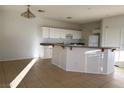 An eat-in kitchen with white cabinets, white appliances and tile floors at 161 Lenape Heights Ave, Las Vegas, NV 89148