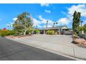 Single story home with a large driveway and mature tree at 1808 Birch St, Las Vegas, NV 89102