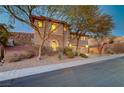 Charming home featuring stone accents, manicured landscaping, and a convenient three-car garage at 2124 Pont National Dr, Henderson, NV 89044