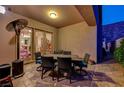 Covered patio with dining table, chairs, and a portable heater at 2124 Pont National Dr, Henderson, NV 89044