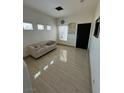 Living room with tile floors and access to kitchen at 2130 Trebbiano Way, Las Vegas, NV 89156