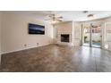 Living room with tile floors, a fireplace, and sliding glass doors that open to the backyard pool at 2244 Brighton Shore St, Las Vegas, NV 89128