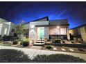 Charming single-story home featuring a modern design, xeriscaped front yard, and a lovely turquoise front door at 2498 Veronella St, Henderson, NV 89044