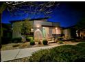 Charming single-story home featuring a modern design, xeriscaped front yard, and a lovely turquoise front door at 2498 Veronella St, Henderson, NV 89044