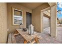 Cozy front porch with outdoor seating, featuring elegant lanterns and a decorative, secure entry door at 2593 Indigo Cloud Ct, Las Vegas, NV 89142