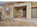 Welcoming front porch features an outdoor sitting area with stylish decor and a secure front door at 2593 Indigo Cloud Ct, Las Vegas, NV 89142