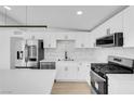 Modern kitchen with stainless steel appliances, quartz countertops, and sleek backsplash at 2801 Emmons Ave, North Las Vegas, NV 89030