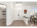 Elegant foyer with chandelier, double doors, and an eye catching dart board at 286 Fairmeadow St, Henderson, NV 89012
