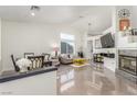 Bright living room with fireplace, modern decor, and glossy tile floors at 286 Fairmeadow St, Henderson, NV 89012