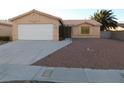 Single story house with a white garage door and gravel landscaping at 4225 Seth Dr, North Las Vegas, NV 89032