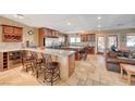 Spacious kitchen featuring granite countertops, stainless steel appliances, wine storage, and a seating area at 4424 Shady Hollow Ave, North Las Vegas, NV 89031