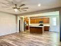 Open concept kitchen with island, stainless steel appliances, and wood cabinets at 5249 Fiery Sky Ridge St, Las Vegas, NV 89148