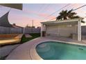 Relaxing backyard oasis with a sparkling pool and pergola at 5509 Evergreen Ave, Las Vegas, NV 89107