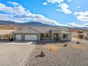 Spacious house with a two-car garage and desert landscape at 6101 Cavalry Trl, Pahrump, NV 89060