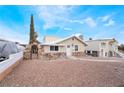 Charming single-story home featuring rock accents, a stone archway, and a gravel-covered yard at 659 D Ave, Boulder City, NV 89005